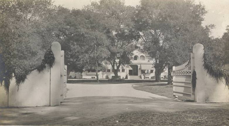 Front of large estate with gate, possibly one of Sarah Winchester homes, 1922