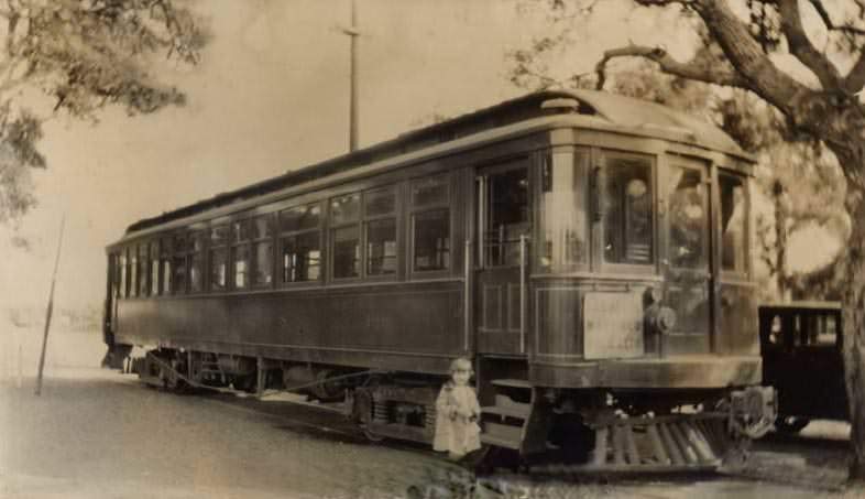 Alice Smothers in front of trolley car, 1920
