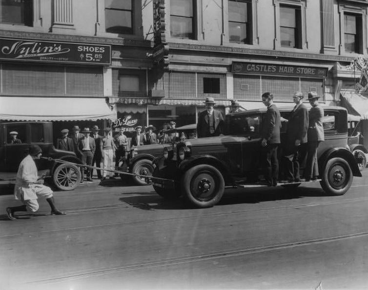 Woman pulling car with teeth, San Jose, California, 1926