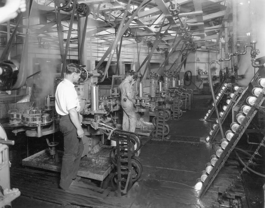 Men working canning machines at Hunt Brothers Packing Company. Cannery was located at 361 North Fourth Street, San Jose, 1925