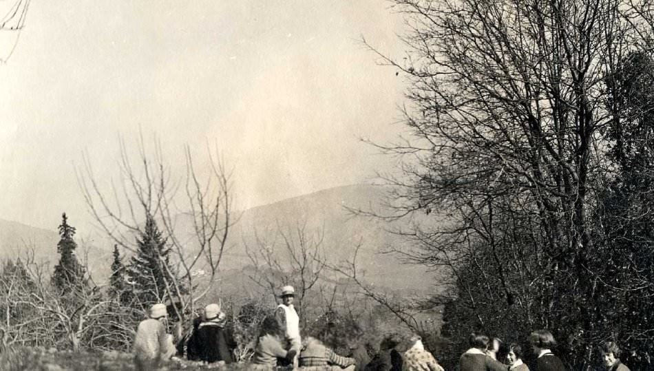Pathfinders sitting on hillside overlooking valley, 1920s