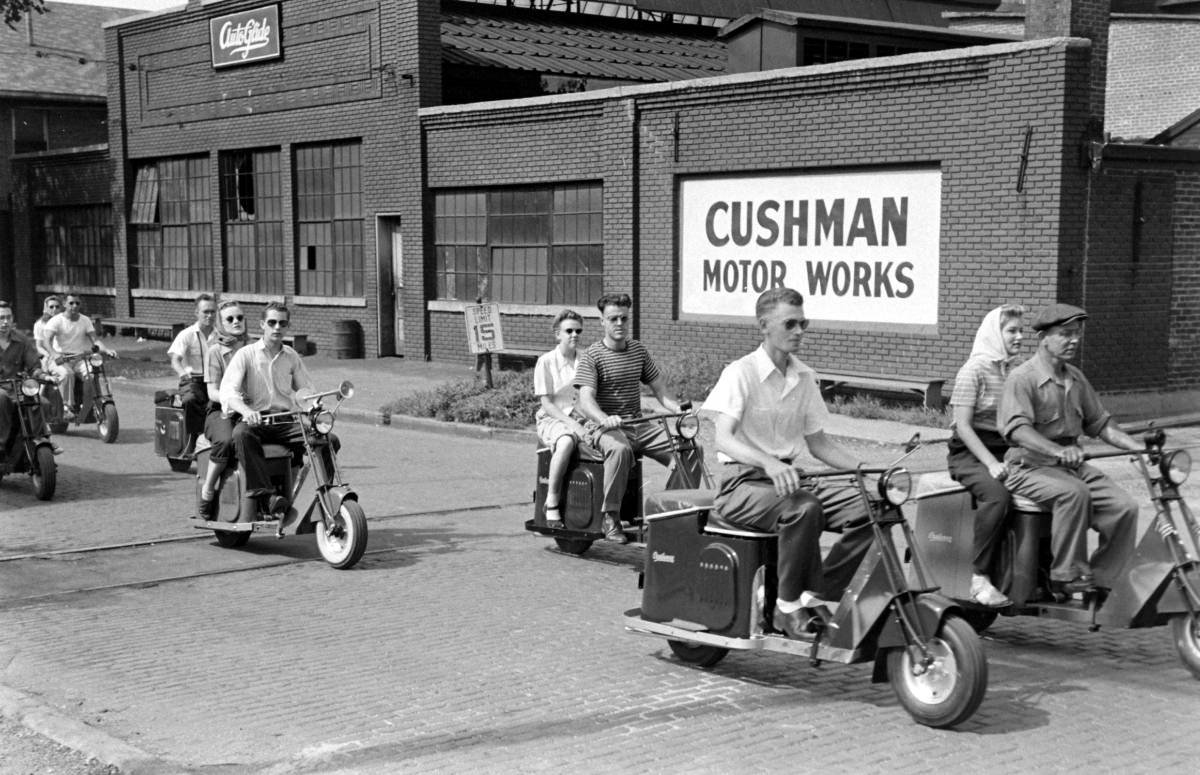 Outside the Cushman Motor Works scooter plant in Nebraska, 1945.