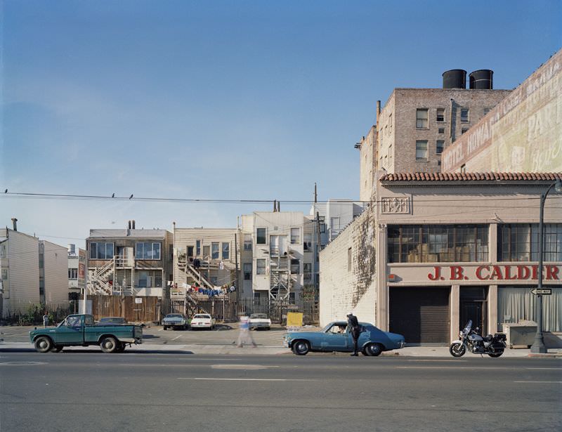 Policeman writing a ticket, Howard near 6th Street, 1980