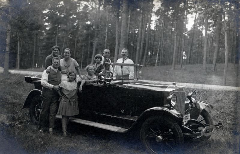 Eight members of a German middle-class family posing with a right-hand drive Steyr VII Tourenwagen in the countryside, 1929