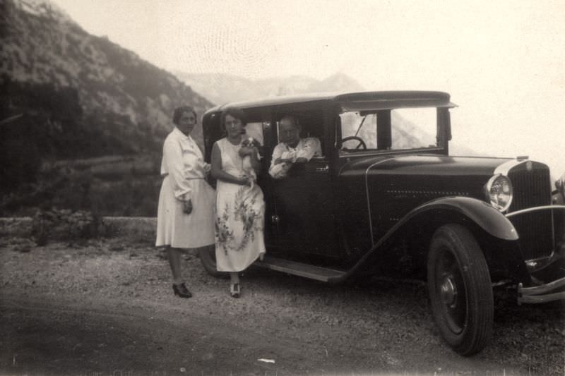 Two ladies in white dresses, a gent and a Steyr XX Weymann Saloon on a mountain road, 1929