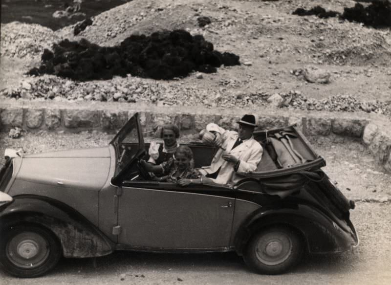People enjoying a break on a mountain road, 1937