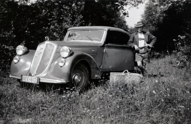 A dapper fellow posing with a Steyr 125 Super in a meadow in summertime, 1938