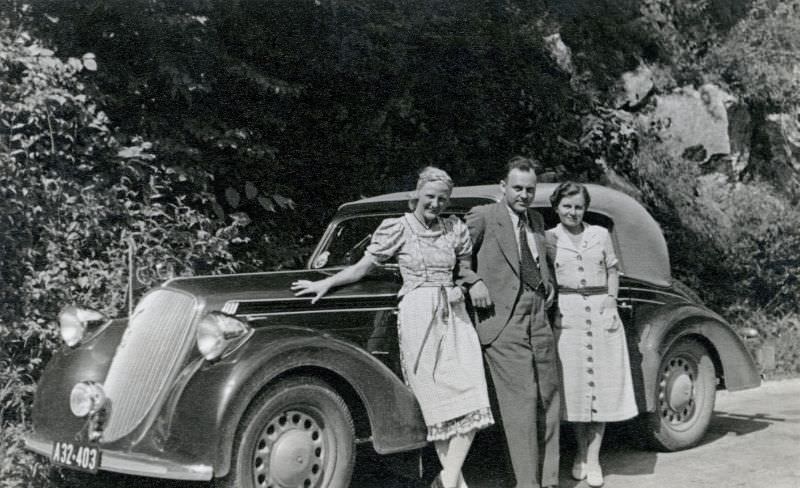 Three members of an Austrian middle-class family posing with a Steyr 220 Cabriolet in the countryside, 1938