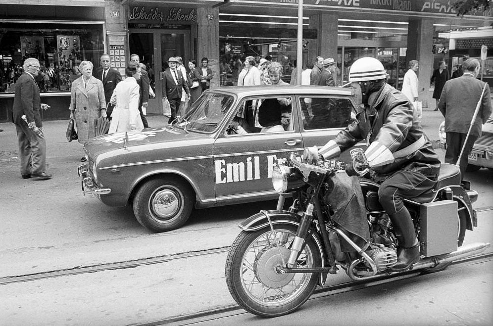 Motorcycle policeman escorting Werner Hornung, magician on blind drive 1970