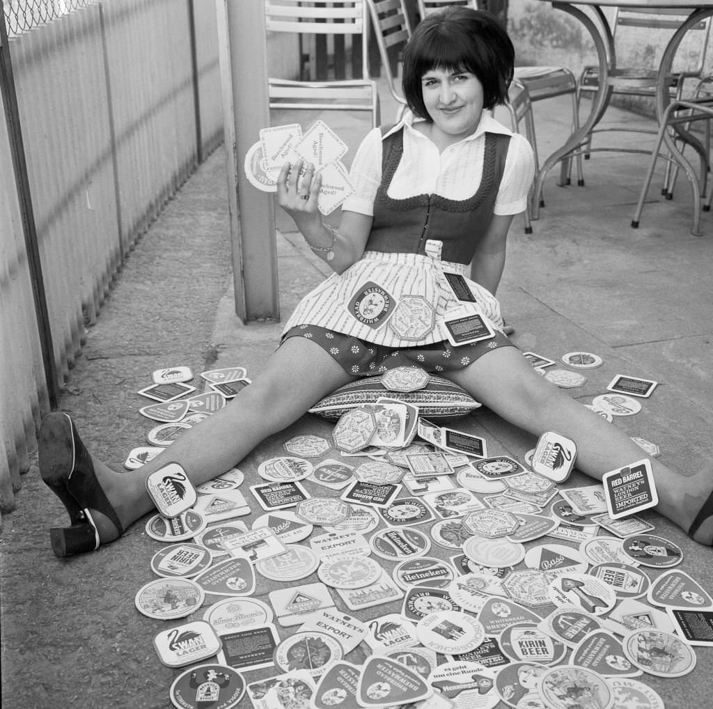 Waitress with different beer mats, 1970