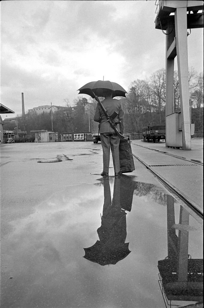 Sodiers wears hut with umbrella, 1970