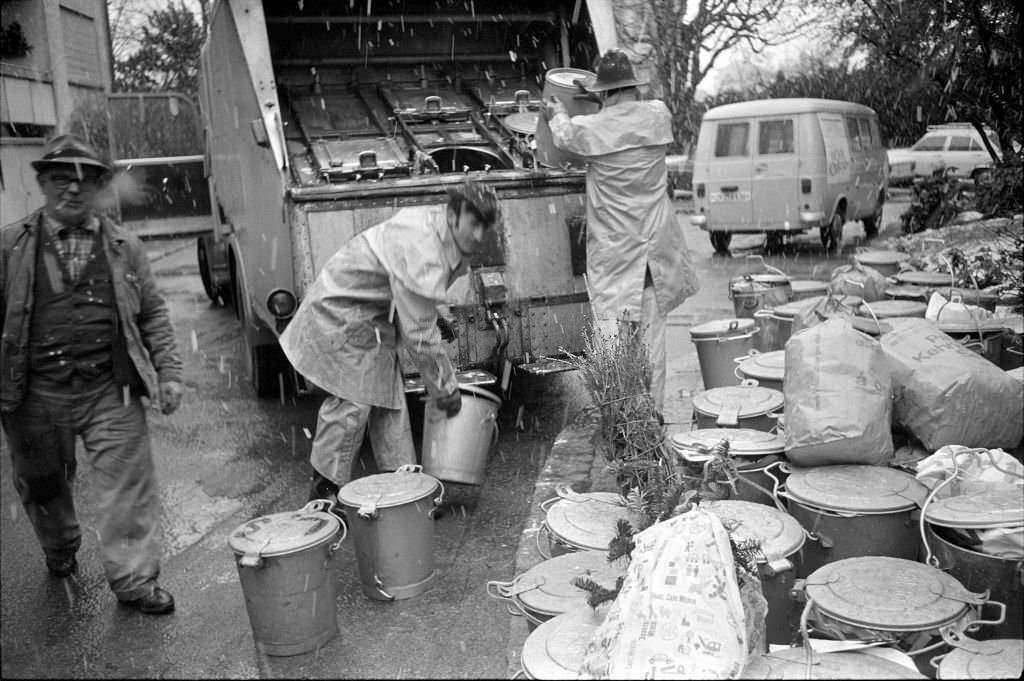 Christmas tree near rubbish bins, 1970