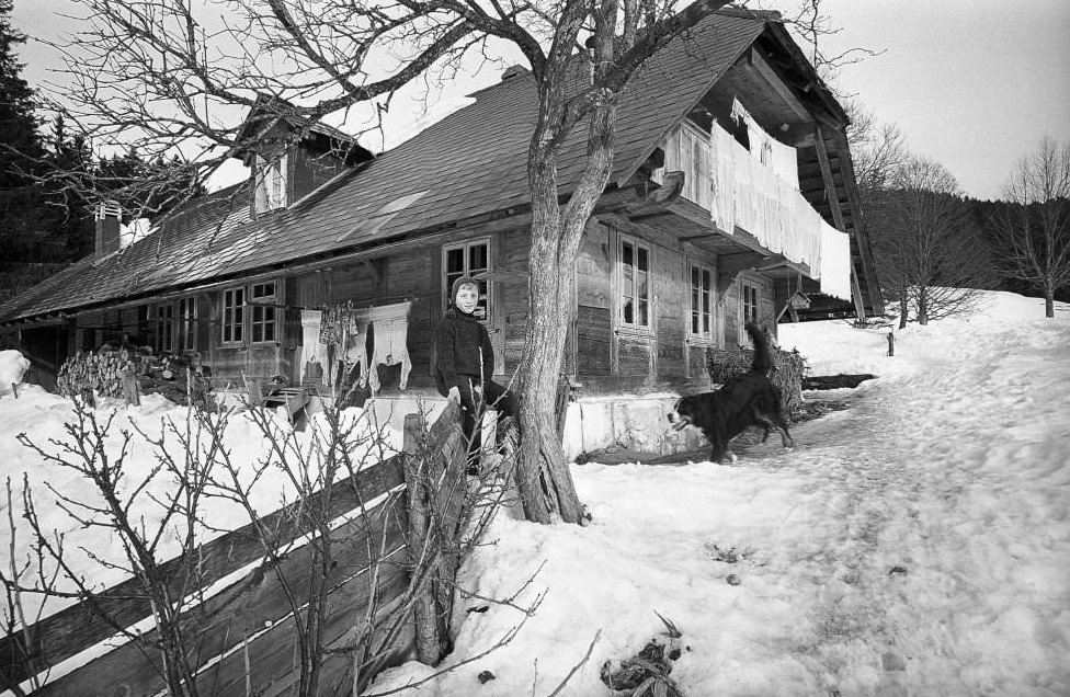 Boy in front of a farmhouse in the Emmental, 1970