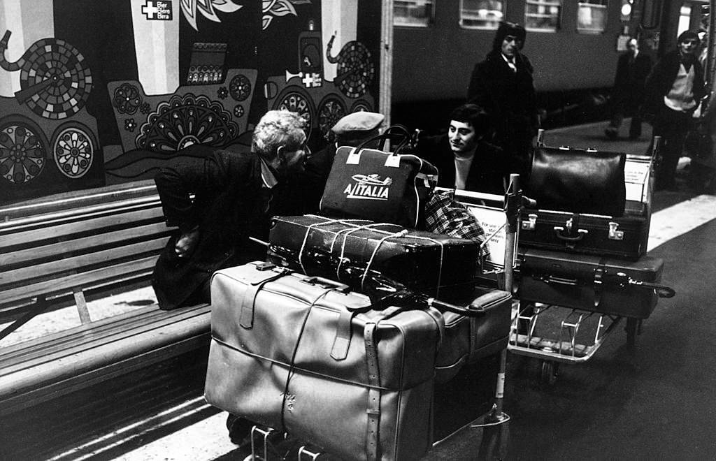 Seasonal Italian emigrants waiting at the train station to go back home. Switzerland, 1970s