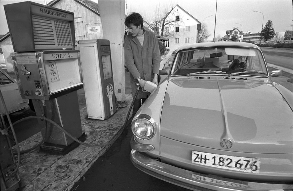 Zurich; filling station attendant at gasoline pump, 1970