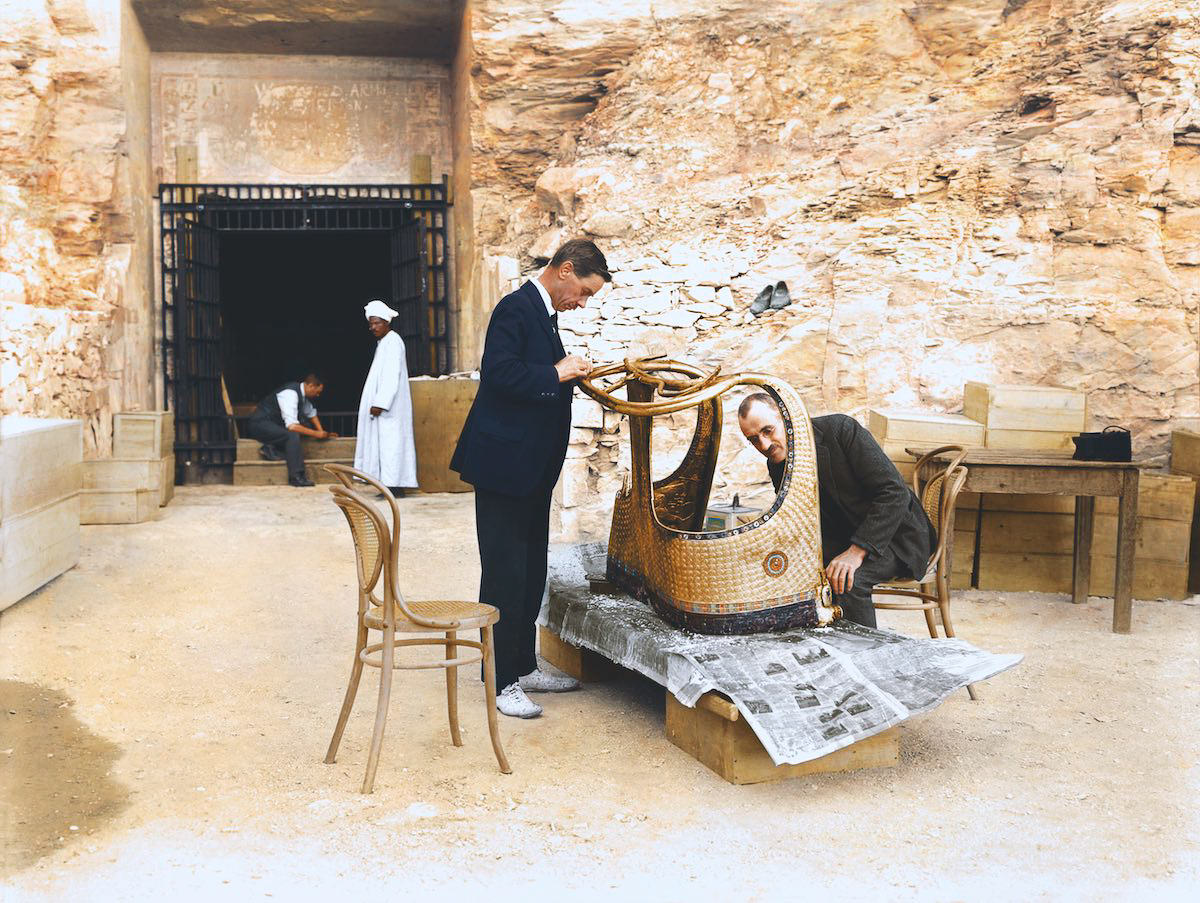 Arthur Mace (left) and Alfred Lucas working outside the 'laboratory' set up in the tomb of Sethos II (KV 15), stabilizing the surface of one of the state chariots (Carter no. 120) found in the Antechamber.
