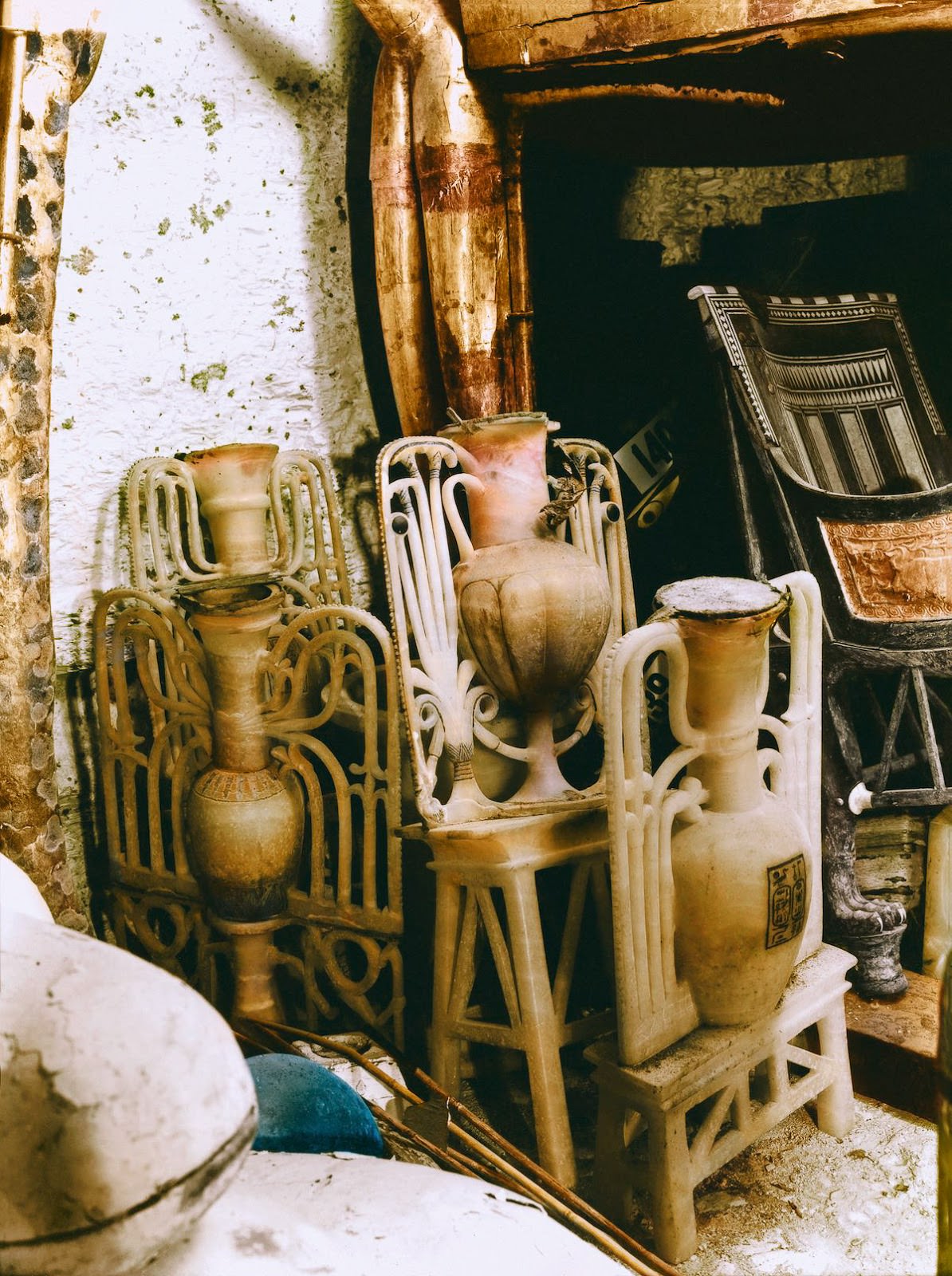 Sealed alabaster 'unguent' vases (Carter nos. 57, 58, 60 and 61) between the cow-headed (Carter no. 73) and lion (Carter no. 35) couches against the west wall of the Antechamber. Tutankhamun's Tomb, December 1922