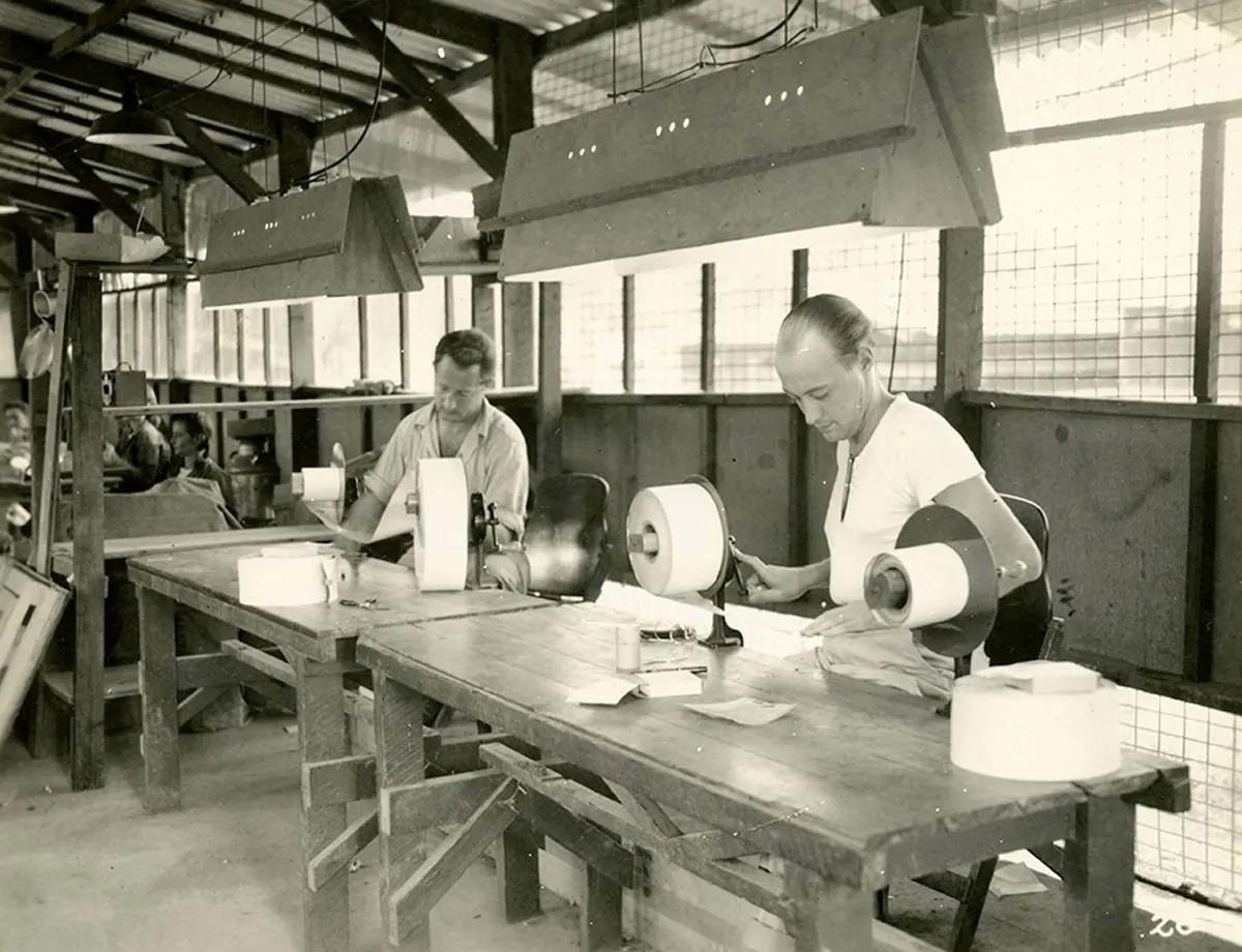 Paper inspection. At these tables, each roll of finished work is inspected letter by letter and all badly reproduced letters are marked out.