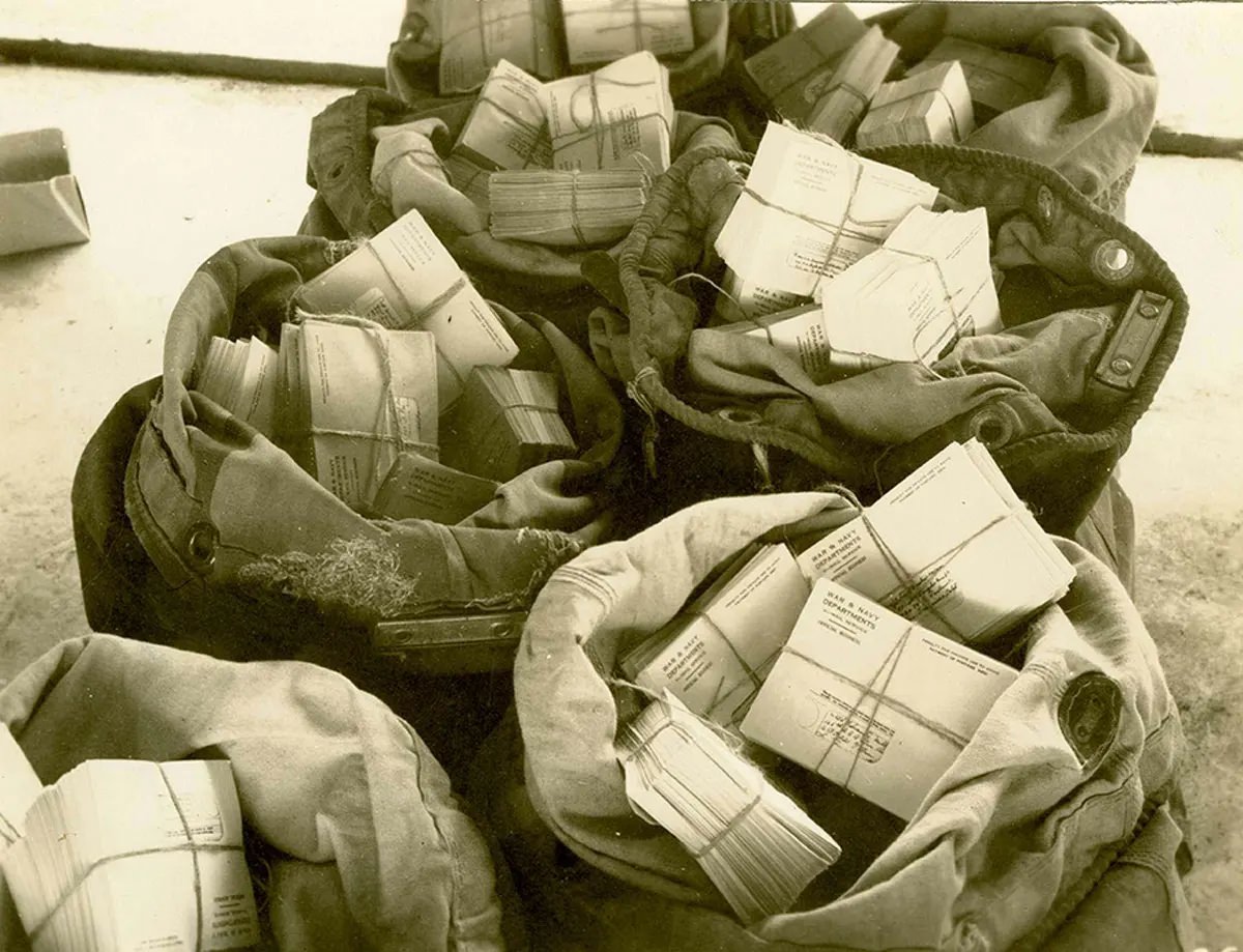 “Finished V-Mail bundled, bagged, and ready for dispatch through the APO to the troops.” Port Moresby, Papua New Guinea, 1944.