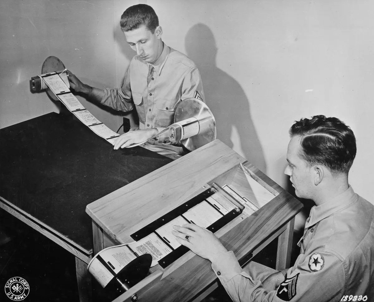 Paper reproductions of V-mail microfilm are inspected and then cut into individual letters by a “chopper.”