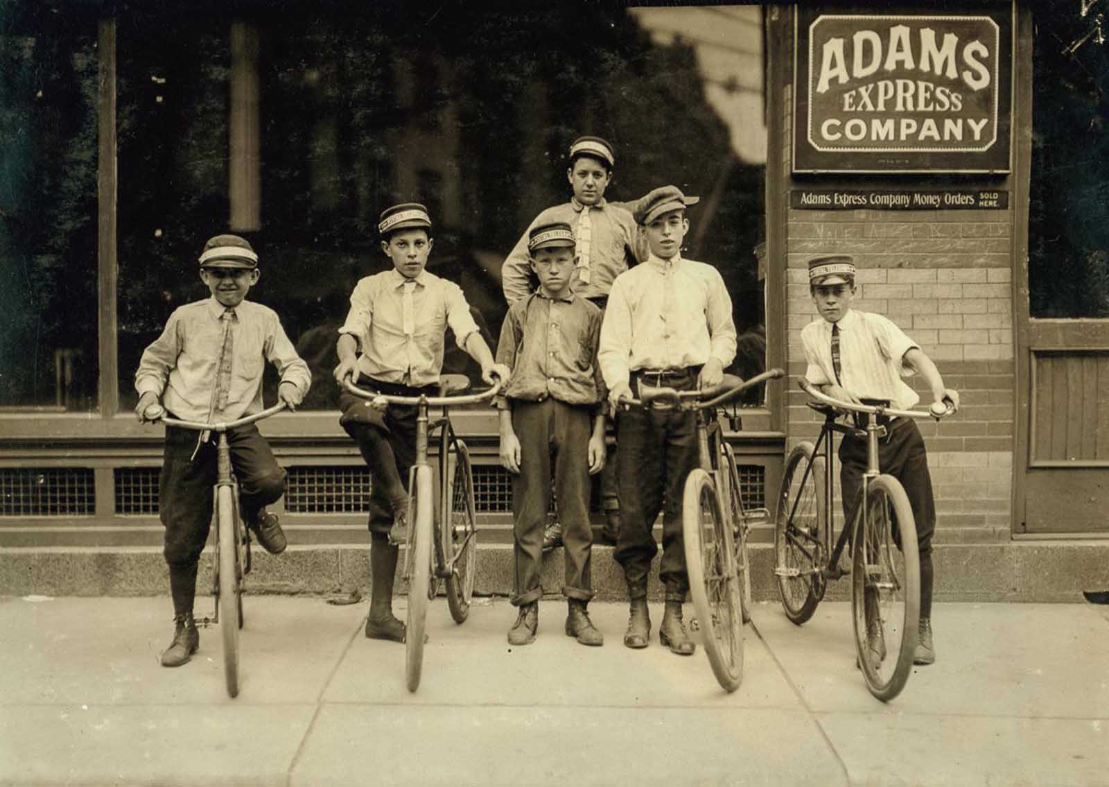 A typical group of Postal Messengers in Norfolk, Va. Smallest on left end, Wilmore Johnson, been there one year. Works days only. The Postal boys are not nearly so young, in Norfolk and also in other Virginia cities, as are the Western Union boys”. June, 1911.
