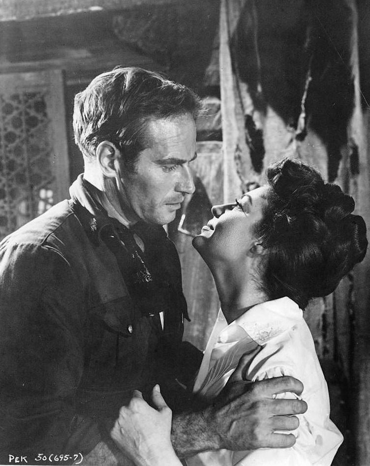 Charlton Heston holds Ava Gardner in a scene from the film '55 Days At Peking', 1963.