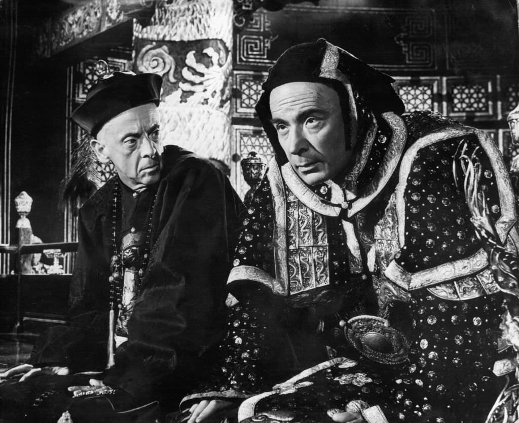 Robert Helpmann looking over at Leo Genn in a scene from the film '55 Days At Peking', 1963.