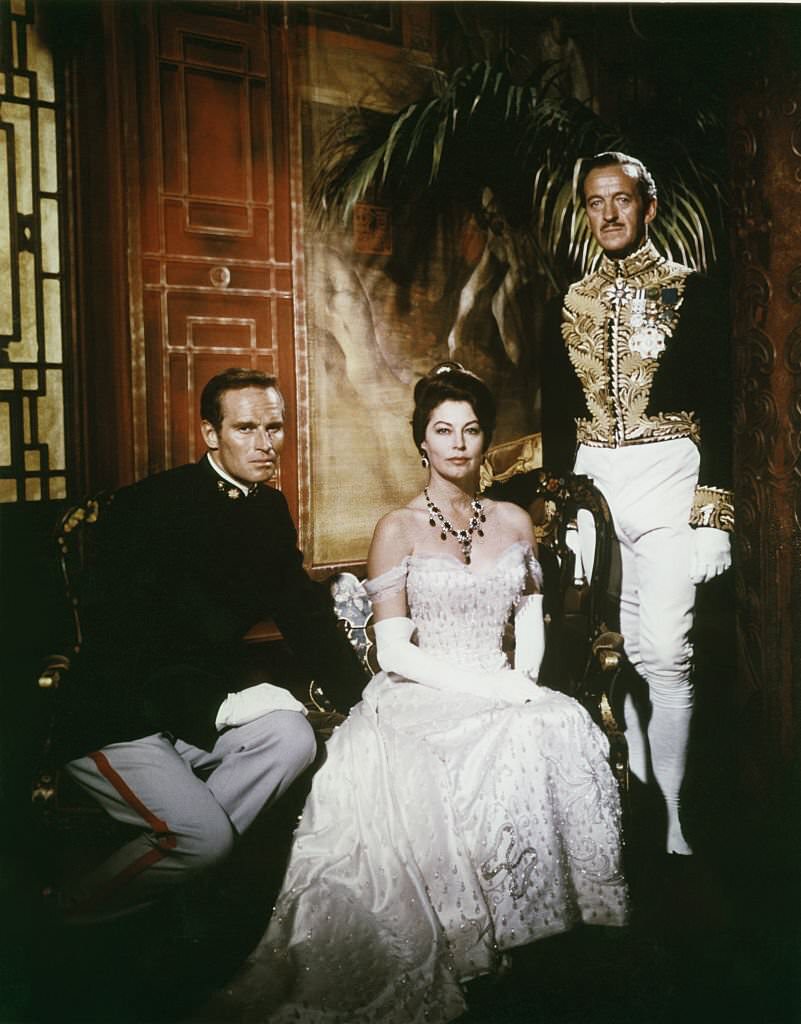 American actors Charlton Heston, David Niven and actress Ava Gardner on the set of '55 Days At Peking', 1963.