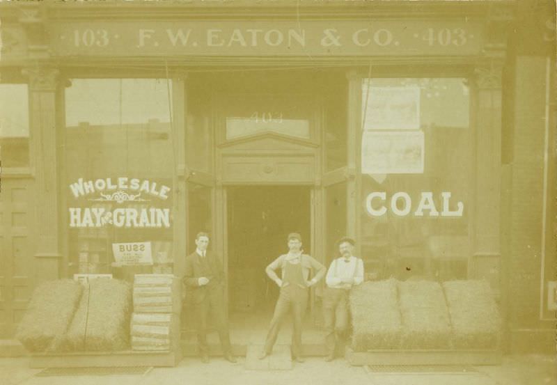 Three men outside of F.W. Eaton & Co. Hay, Grain, & Coal store, 1880s