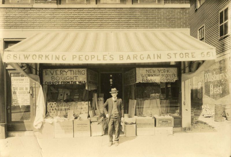 Man standing outside Working People's Bargain Store, New York, 1890s