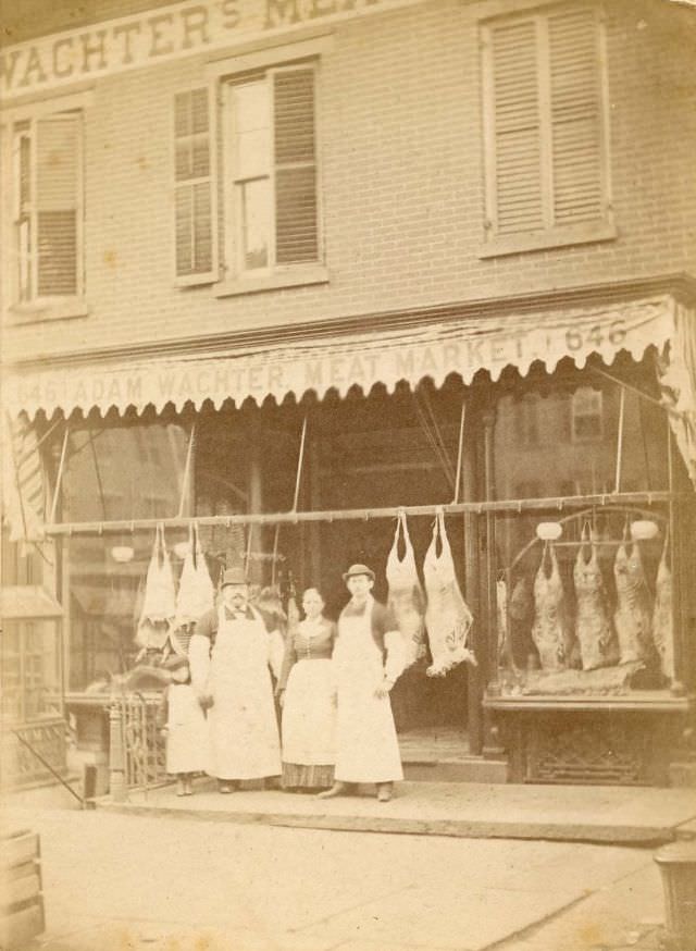 People outside Adam Wachter's Meat Market, New York, 1880s