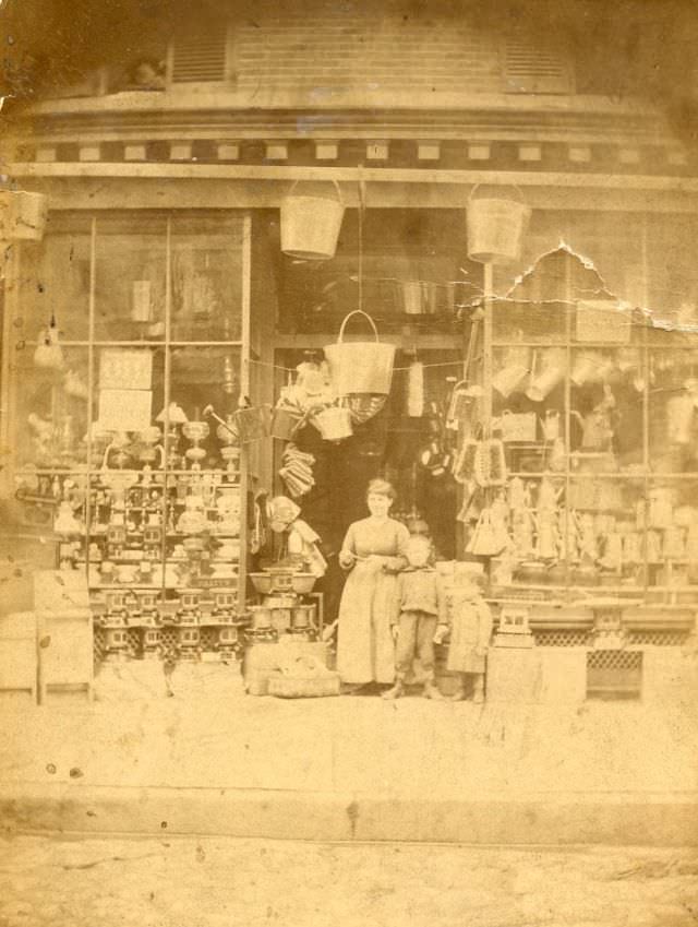 People outside of tinware store, New York, 1870s