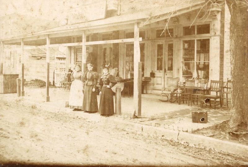 Three women outside general store, 1870s