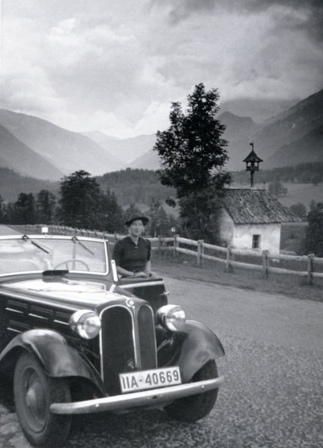 A young lady posing with a BMW 315 Cabriolet in an Alpine landscape, 1938.