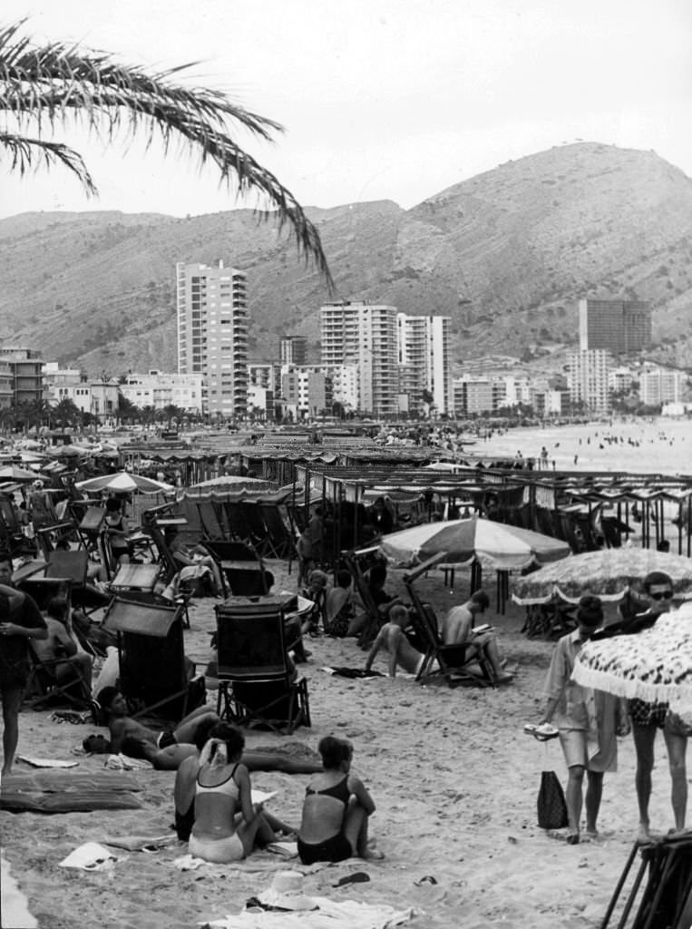 Continental beach scene, with many people sunbathing in Benidorm, Spain, 1960s