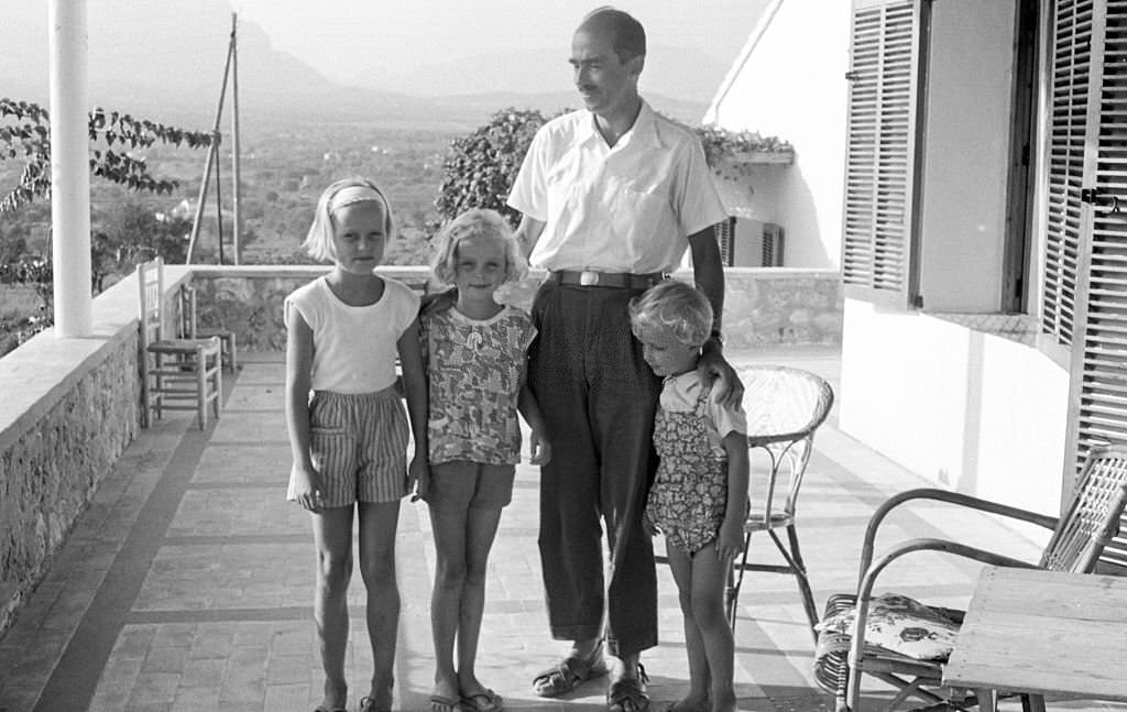 Grand Duke Otto von Habsburg as he poses with three of his daughters during a holiday, Benidorm, Alicante, Spain, 1963.