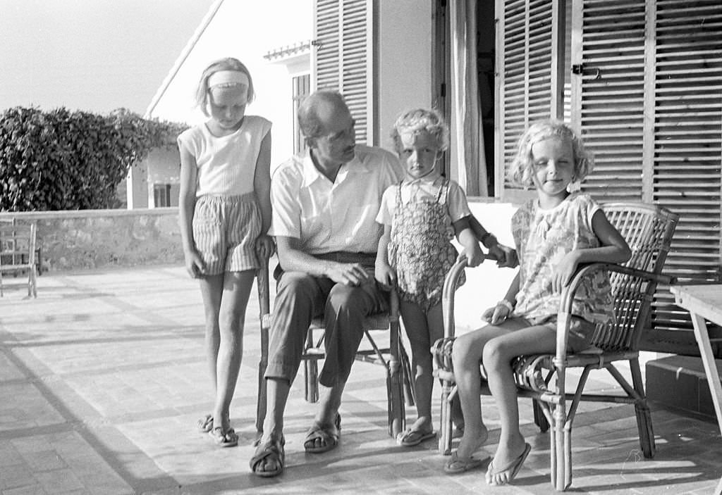 Grand Duke Otto von Habsburg as he poses with three of his daughters during a holiday, Benidorm, Alicante, Spain, 1963.