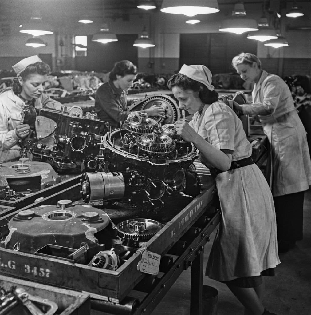 Female factory workers assemble parts, possibly the reduction gear, for Rolls-Royce Merlin V-12 piston aero engines at the Hillington Rolls-Royce aero engine factory in Glasgow, Scotland on 30th November 1942.