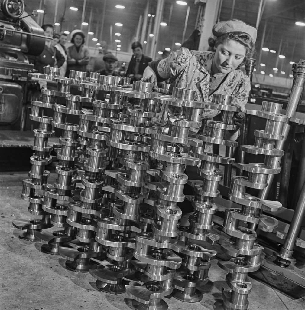 A female factory worker polishes completed crankshafts for fitting in Rolls-Royce Merlin V-12 piston aero engines at the Hillington Rolls-Royce aero engine factory in Glasgow, Scotland on 30th November 1942.