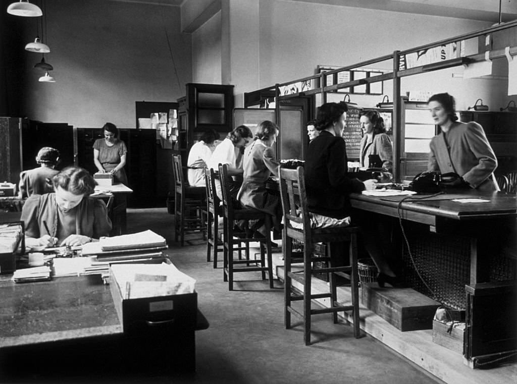 Women applicants at the counter of Tooting Labour Exchange, signing up for employment in essential war work.