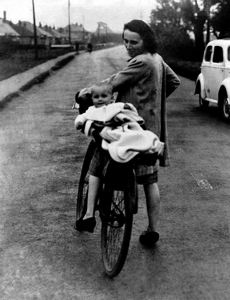 Women and baby seen here leaving the city for the country side to avoid the nightly bombing. September 1941