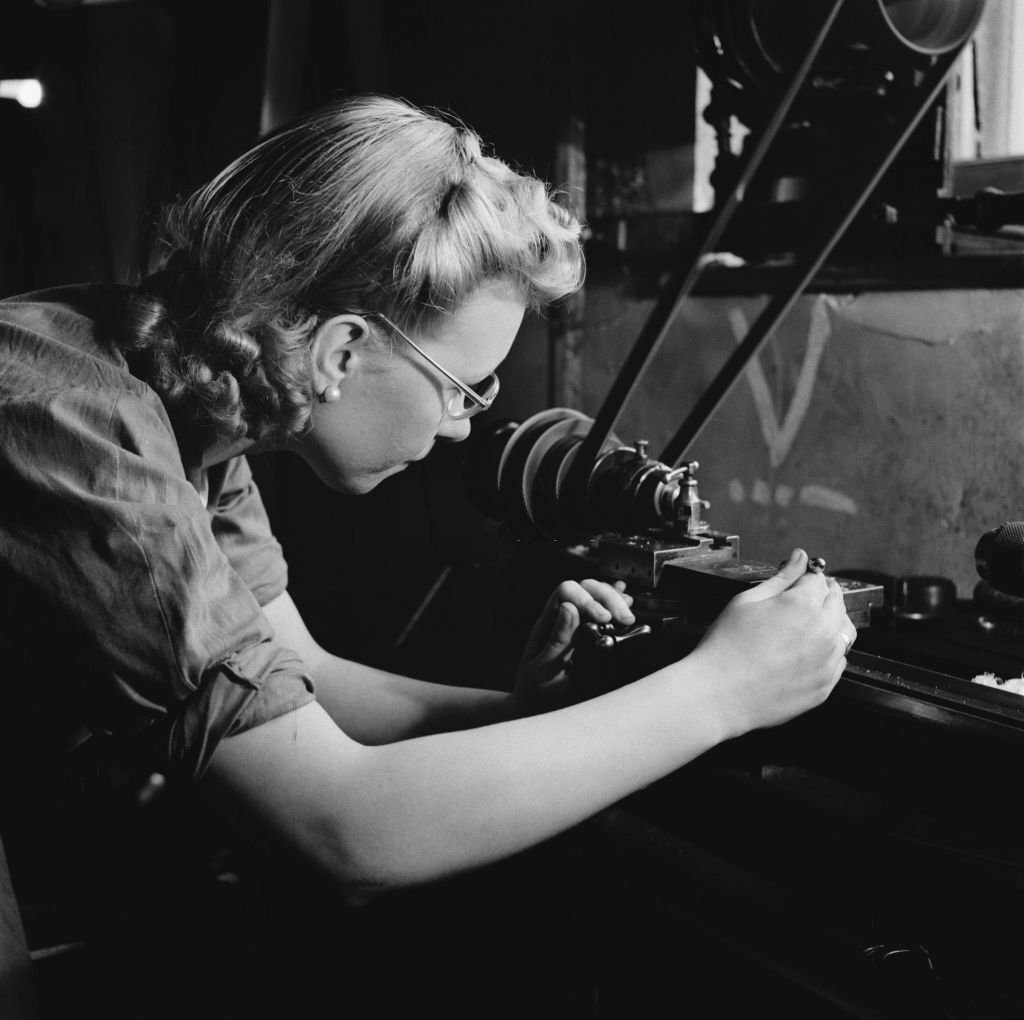 A young woman training for war work in the machine shop of the Ministry of Labour training centre at Chelsea Polytechnic, later the Chelsea College of Arts in London, July 1941.