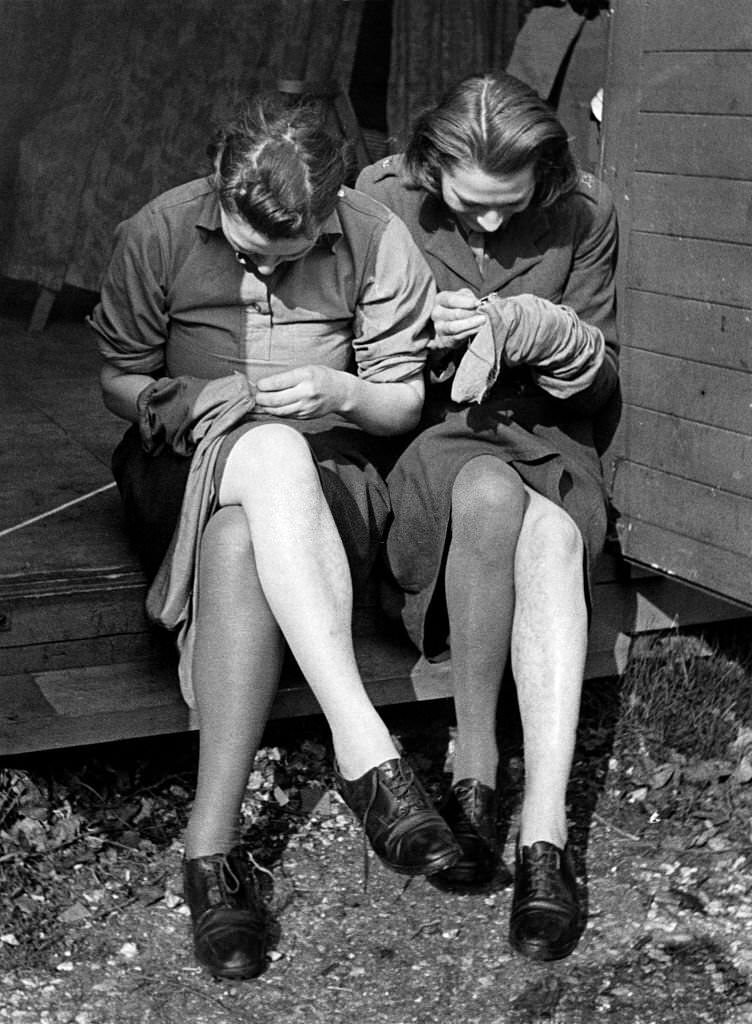 Mending their stocking at training and reception Depot for ATS girls in Aldermaston, Berkshire, April 1941