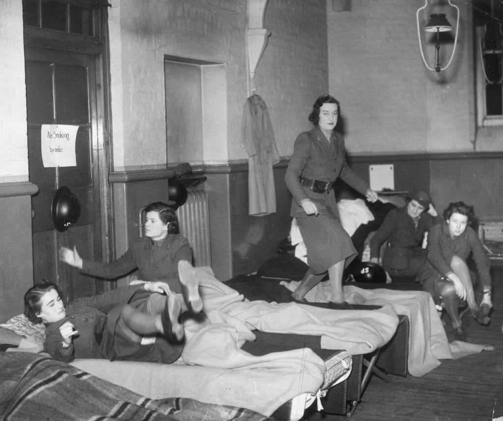 Members of the Mechanised Transport Corps in their dormitory where they sleep with their clothes when on duty, 1940