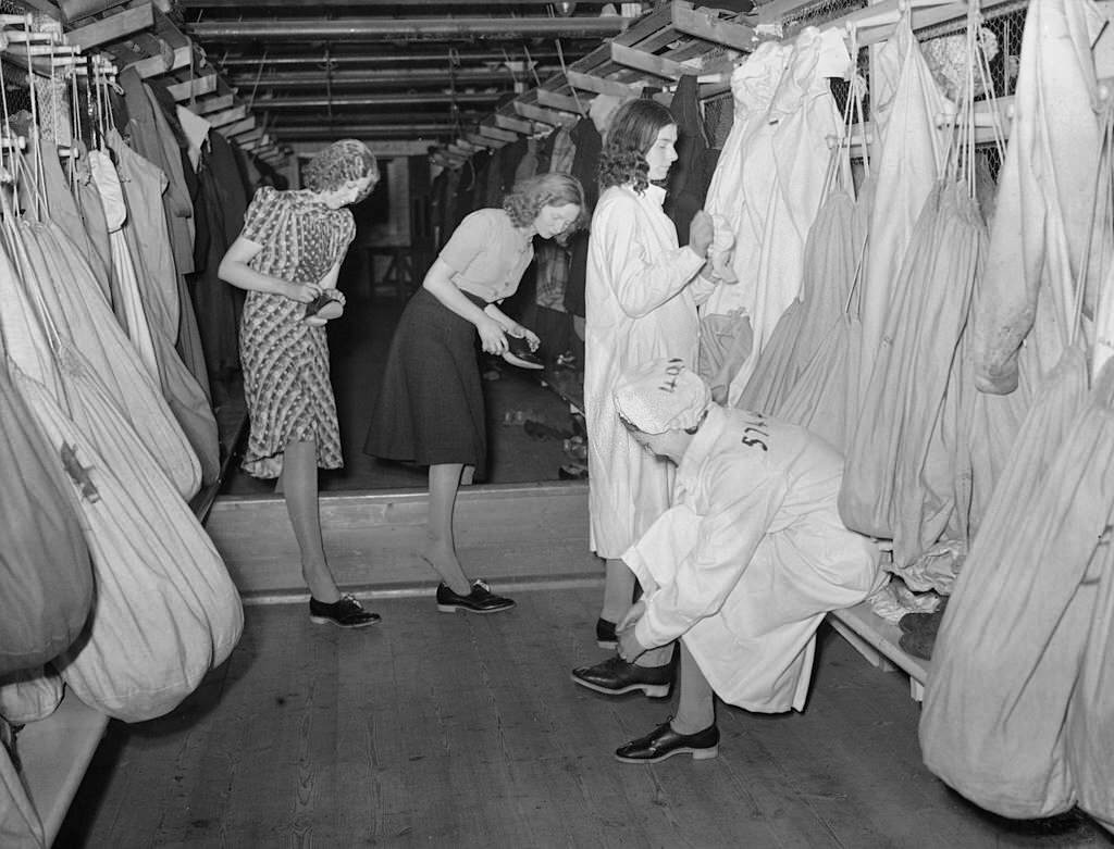 Female staff at an Arms Factory somewhere in Britain, prepare for work in the factory changing area.