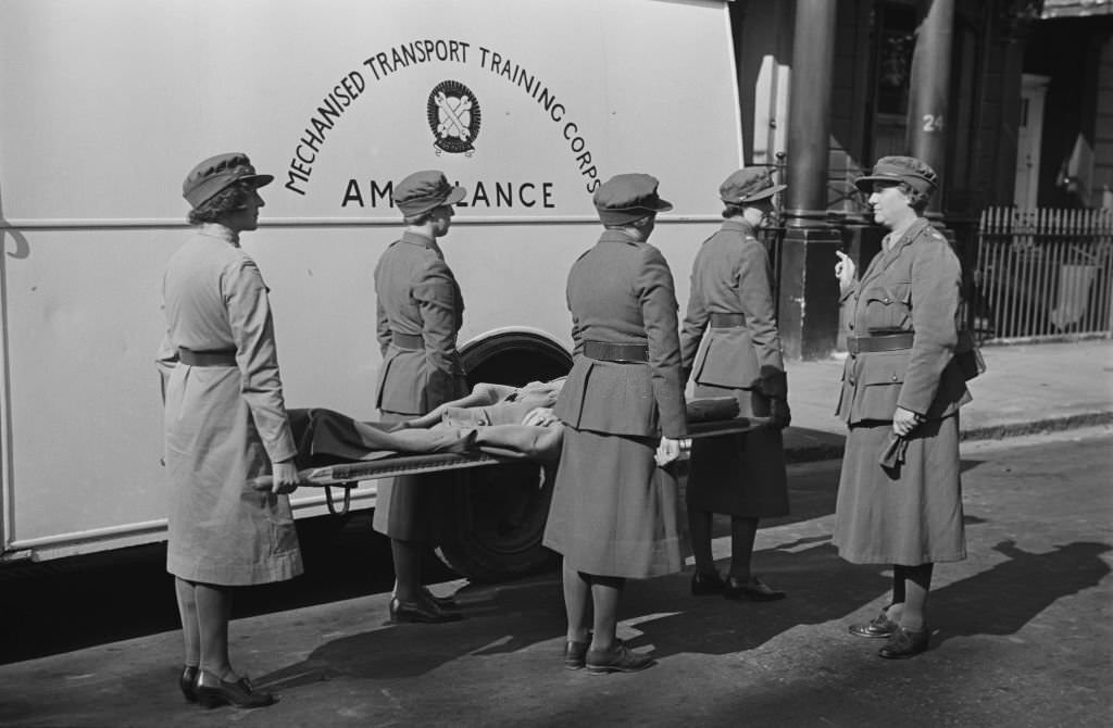 Commandant of the Women's Mechanised Transport Training Corps (MTTC), Mrs G M Cook gives instructions to four female MTTC stretcher bearers beside an ambulance in London on 28th September 1939.