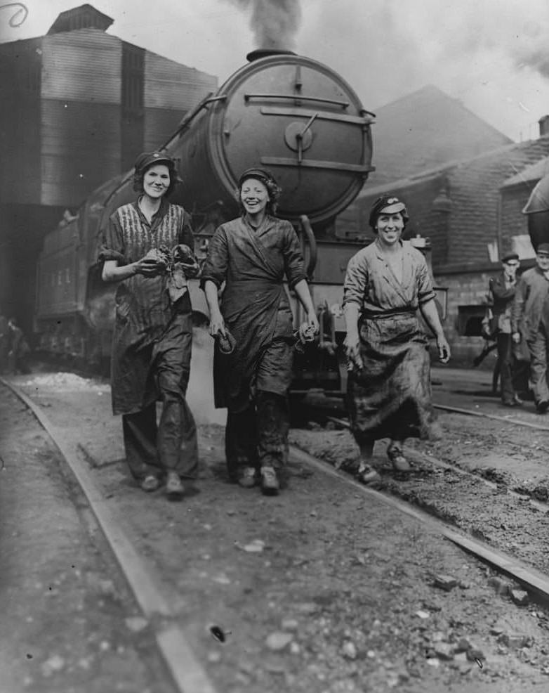 Three cleaners, nicknamed the Three Musketeers, who are employed to clean and maintain locomotives at the London and North Eastern Railway yard, Northern England, June 1941.