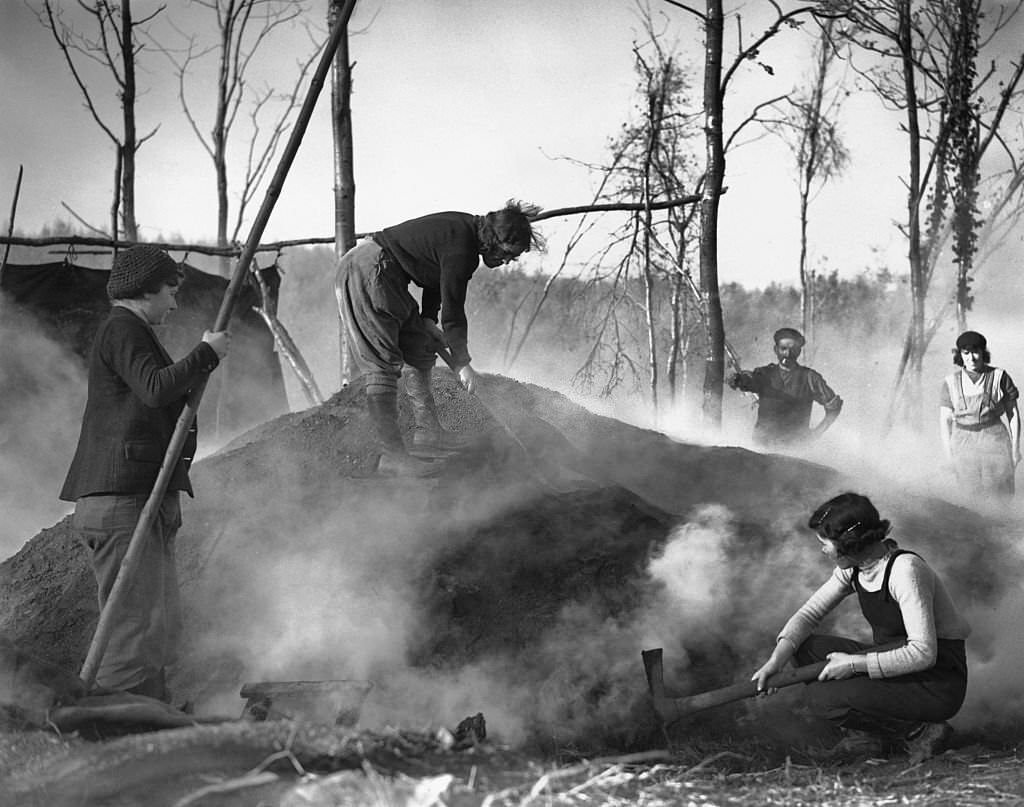 Land army girls helping a charcoal burner in the West Country, 1940.