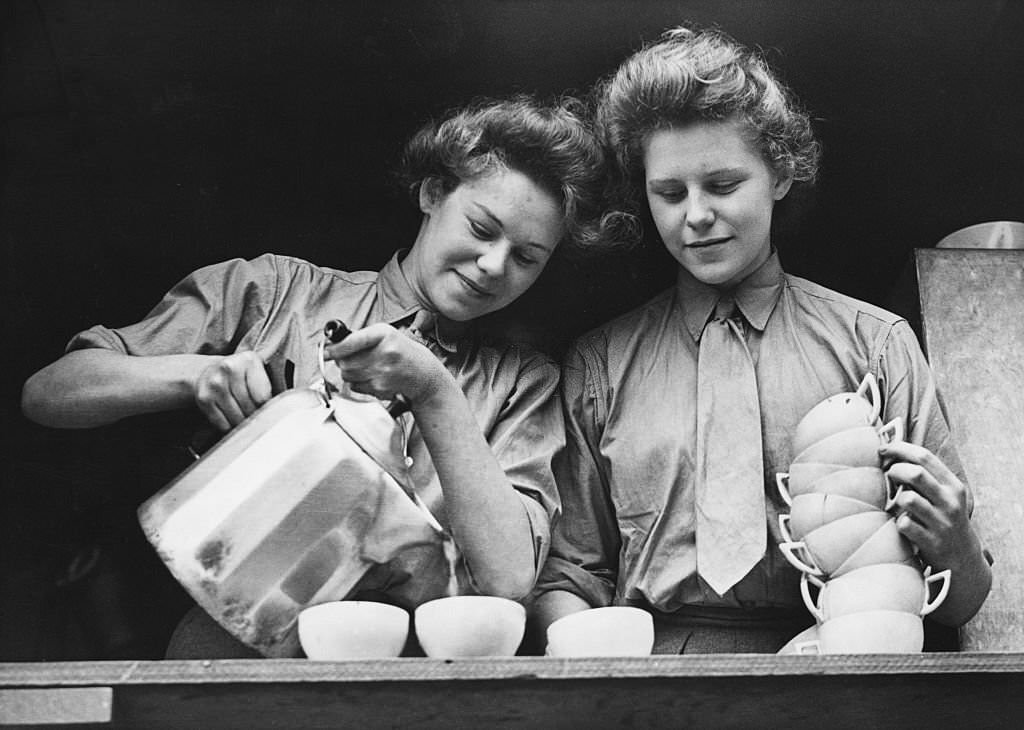 Members of the A.T.S (Auxiliary Territorial Service) pour tea at the canteen of the Vehicle Reserve Depot, July 1943.