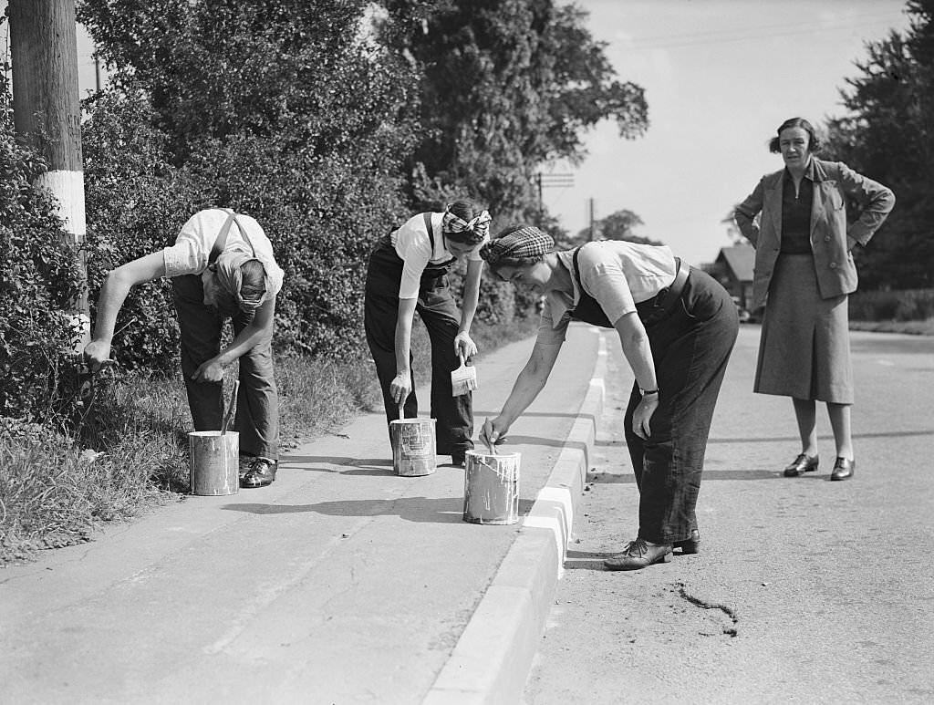 Women Road Painters, 1941. Women doing men's jobs, painting the kerb white so it can be seen during the blackout in World War Two.
